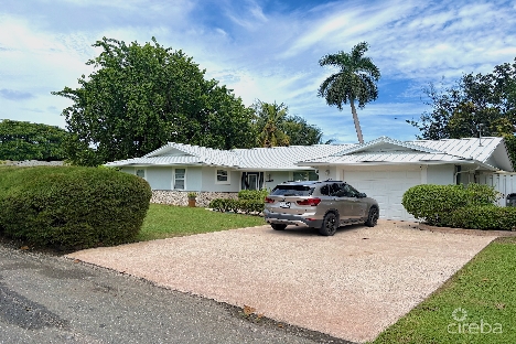 Rare double-lot oasis bungalow  with pool in snug harbour