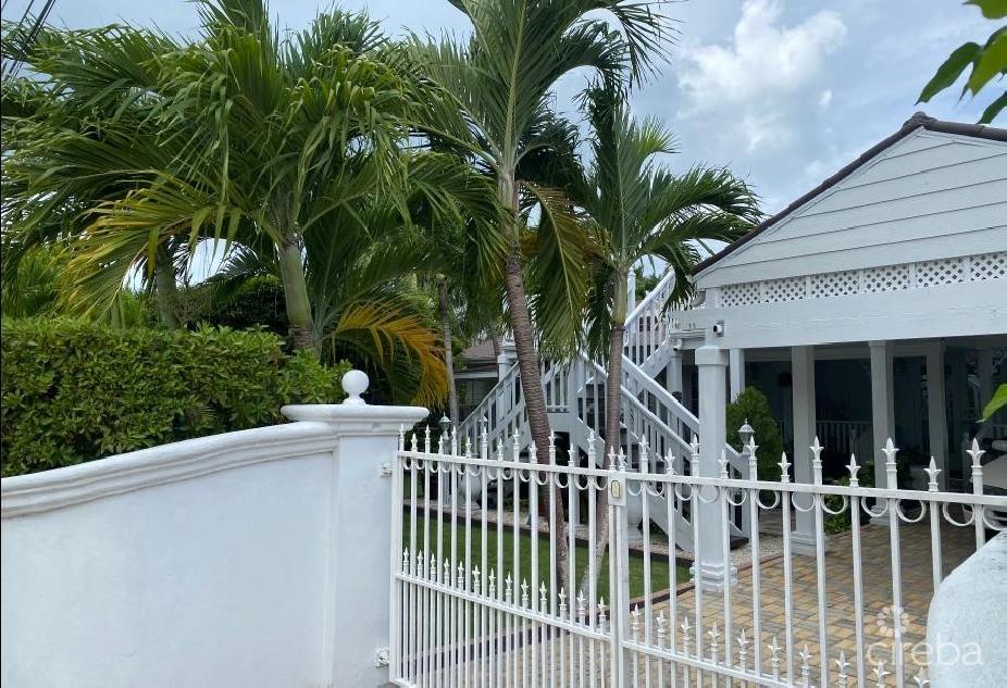 Immaculate triplex with tropical oasis & rental income potential