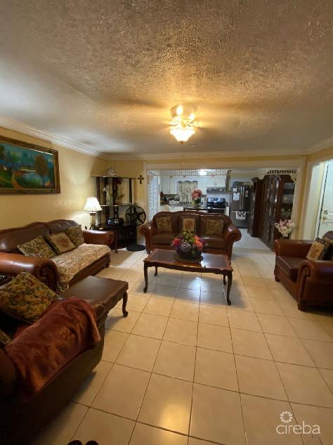 Immaculate triplex with tropical oasis & rental income potential